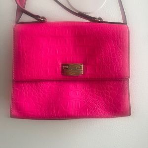 Off the shoulder hot pink Kate Spade bag with gold accents